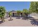 Private backyard featuring mature trees, a brick patio, and a decorative fountain at 662 W Elena Ave, Mesa, AZ 85210