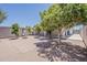 Serene backyard featuring mature trees, a quaint water fountain, and a charming brick-paved patio area perfect for outdoor relaxation at 662 W Elena Ave, Mesa, AZ 85210