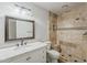 Bathroom featuring a white vanity with marble top and tiled walk-in shower at 662 W Elena Ave, Mesa, AZ 85210