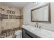 Bathroom featuring a stylish vanity, and a tile shower with designer accents at 662 W Elena Ave, Mesa, AZ 85210