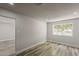 Bright bedroom with recessed lighting, wood-look flooring, and a large window at 662 W Elena Ave, Mesa, AZ 85210