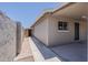 Exterior view highlighting the home's architectural details, including a covered walkway and access to an outdoor storage shed at 662 W Elena Ave, Mesa, AZ 85210