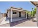 Exterior view of a cozy home featuring a covered patio, showcasing a tidy yard with desert landscaping and a private entrance at 662 W Elena Ave, Mesa, AZ 85210