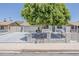 Inviting home featuring desert landscaping, a charming front fence, and a lush, mature shade tree at 662 W Elena Ave, Mesa, AZ 85210