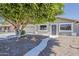 Charming single-story home with a desert landscape and a mature shade tree in the front yard at 662 W Elena Ave, Mesa, AZ 85210