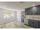 Bright kitchen with stainless steel appliances, granite counters, and a view to the spacious backyard at 662 W Elena Ave, Mesa, AZ 85210