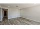 Bright living room featuring sleek, modern gray wood-look flooring and recessed lighting at 662 W Elena Ave, Mesa, AZ 85210