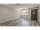 Bright, open living area with modern wood flooring and a view of the front yard at 662 W Elena Ave, Mesa, AZ 85210