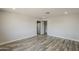 Spacious, neutral-toned living room with wood-look floors, recessed lights, and open access to the kitchen at 662 W Elena Ave, Mesa, AZ 85210