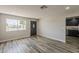 Bright living room with wood-look floors, recessed lighting, and a large window for natural light at 662 W Elena Ave, Mesa, AZ 85210