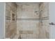 Shower featuring neutral toned tile and a shower niche at 662 W Elena Ave, Mesa, AZ 85210