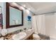 Cozy bathroom features a granite-topped vanity, decorative mirror, and bathtub with shower at 700 E Mesquite Cir # J135, Tempe, AZ 85288