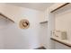 Bright walk-in closet with ample shelving, clothing rods, and a safe for secure storage at 700 E Mesquite Cir # J135, Tempe, AZ 85288