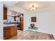 Open-concept dining area with wood floors seamlessly connects to the updated kitchen at 700 E Mesquite Cir # J135, Tempe, AZ 85288