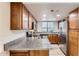 Updated kitchen with granite countertops, stainless steel appliances, and wood cabinetry at 700 E Mesquite Cir # J135, Tempe, AZ 85288