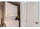 Convenient laundry area with a stacked washer and dryer for efficient space-saving at 700 E Mesquite Cir # J135, Tempe, AZ 85288