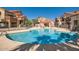 Community pool surrounded by well-maintained condos, lounge chairs, and a cabana at 700 E Mesquite Cir # J135, Tempe, AZ 85288