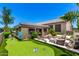 Entertainer's backyard with outdoor kitchen, fire pit lounge, and putting green at 7002 S Portland Ave, Gilbert, AZ 85298