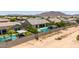 Aerial view of a backyard with a sparkling pool, landscaped greenery, and a covered patio area at 7002 S Portland Ave, Gilbert, AZ 85298