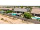 A close aerial view of a backyard showcasing a modern pool, a covered patio, and lush landscaping at 7002 S Portland Ave, Gilbert, AZ 85298