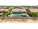 An aerial perspective of a stunning backyard featuring a large, sparkling pool, green lawns and desert landscaping at 7002 S Portland Ave, Gilbert, AZ 85298