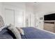 Comfortable bedroom featuring plush bedding and multiple access points to the connected bathroom and hallway at 7002 S Portland Ave, Gilbert, AZ 85298