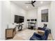 Bedroom with recessed lights, ceiling fan, and seating area with two blue chairs perfect for office space at 7002 S Portland Ave, Gilbert, AZ 85298