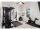 Bright workout room with a peloton, weights, and a full mirror for exercise and fitness at 7002 S Portland Ave, Gilbert, AZ 85298