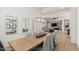 Beautiful dining room area with an elongated table, modern light fixtures, and mirrors at 7002 S Portland Ave, Gilbert, AZ 85298