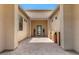 Inviting walkway leading to the front door with beautiful potted plants at 7002 S Portland Ave, Gilbert, AZ 85298