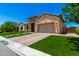 Well-maintained home with artificial lawn, brick driveway, and attached two-car garage at 7002 S Portland Ave, Gilbert, AZ 85298