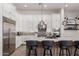 Close-up of a modern kitchen island with granite countertops and stainless steel appliances at 7002 S Portland Ave, Gilbert, AZ 85298