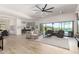 Open living space featuring modern ceiling fan, tile floors, and backyard pool views at 7002 S Portland Ave, Gilbert, AZ 85298