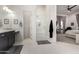 This stylish main bathroom showcases a glass shower and dual sink vanity providing both elegance and functionality at 7002 S Portland Ave, Gilbert, AZ 85298