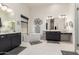 Elegant main bathroom with a freestanding tub, dual sinks, and modern fixtures, creating a spa-like experience at 7002 S Portland Ave, Gilbert, AZ 85298