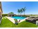 Backyard oasis featuring a sparkling pool, lush landscaping, and poolside lounge chairs at 7002 S Portland Ave, Gilbert, AZ 85298