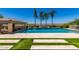 Backyard with a beautiful pool featuring tile accents, grass inserts, and water features at 7002 S Portland Ave, Gilbert, AZ 85298
