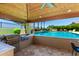 Outdoor kitchen equipped with built-in grill and bar seating, adjacent to the refreshing pool at 7002 S Portland Ave, Gilbert, AZ 85298