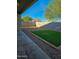 Backyard features a low-maintenance gravel area, green artificial turf, and a covered patio at 7321 N 123Rd Dr, Glendale, AZ 85307
