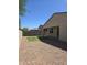 Spacious backyard includes a block wall, low-maintenance gravel, and artificial turf at 7321 N 123Rd Dr, Glendale, AZ 85307