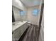 Bathroom featuring a double sink vanity, and sleek gray flooring at 7321 N 123Rd Dr, Glendale, AZ 85307