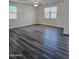 Bedroom with gray wood flooring, ceiling fan, and large windows at 7321 N 123Rd Dr, Glendale, AZ 85307