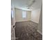 Bedroom featuring brown carpet flooring, ceiling fan and white walls with large windows at 7321 N 123Rd Dr, Glendale, AZ 85307