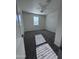 Bedroom featuring gray carpet flooring, ceiling fan and white walls with large windows at 7321 N 123Rd Dr, Glendale, AZ 85307