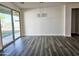 Bright dining room with gray wood-style floors and sliding glass door to the back yard at 7321 N 123Rd Dr, Glendale, AZ 85307