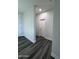 Hallway with gray wood flooring and white walls leading to a bedroom at 7321 N 123Rd Dr, Glendale, AZ 85307