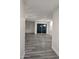 Hallway with gray wood-style floors that leads to the dining room with a sliding glass door at 7321 N 123Rd Dr, Glendale, AZ 85307