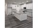 Kitchen featuring white cabinets, granite countertops, and center island for dining and food prep at 7321 N 123Rd Dr, Glendale, AZ 85307