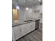 Close up of the kitchen island featuring a stainless steel sink and dishwasher with granite countertops at 7321 N 123Rd Dr, Glendale, AZ 85307
