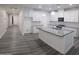 Bright open kitchen with white cabinets, gray countertops, stainless appliances, and a spacious island at 7321 N 123Rd Dr, Glendale, AZ 85307
